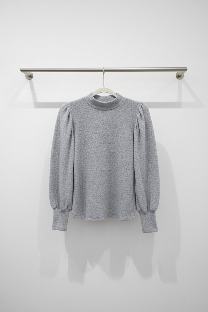 A light gray long-sleeve knit sweater